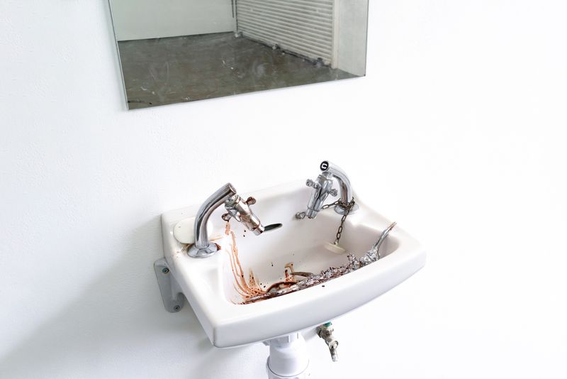 Close up of Bailey's work inside exhibition Mudlark