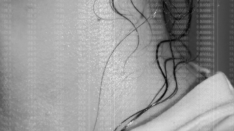 Still from Yasmin Vardi's film Sweatshop, close up of woman's neck sweating